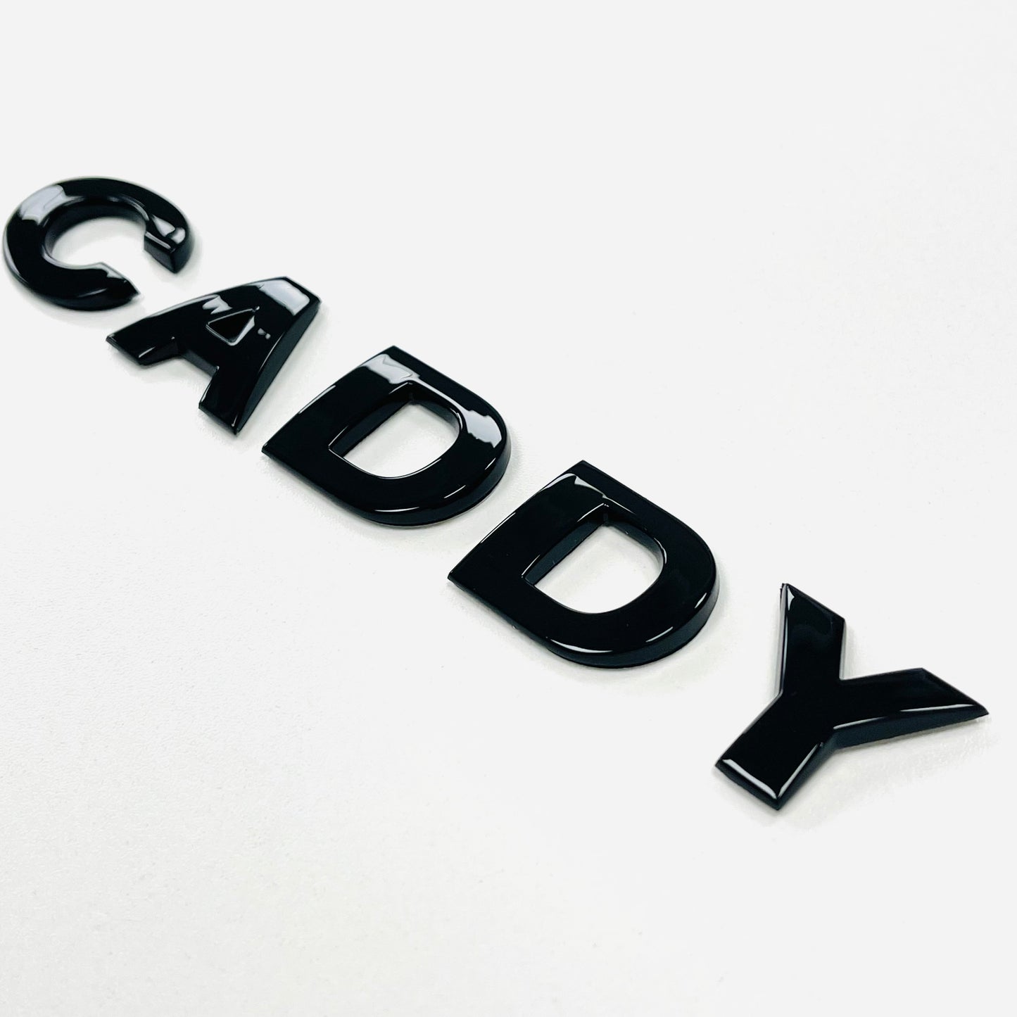 CADDY gloss black badge