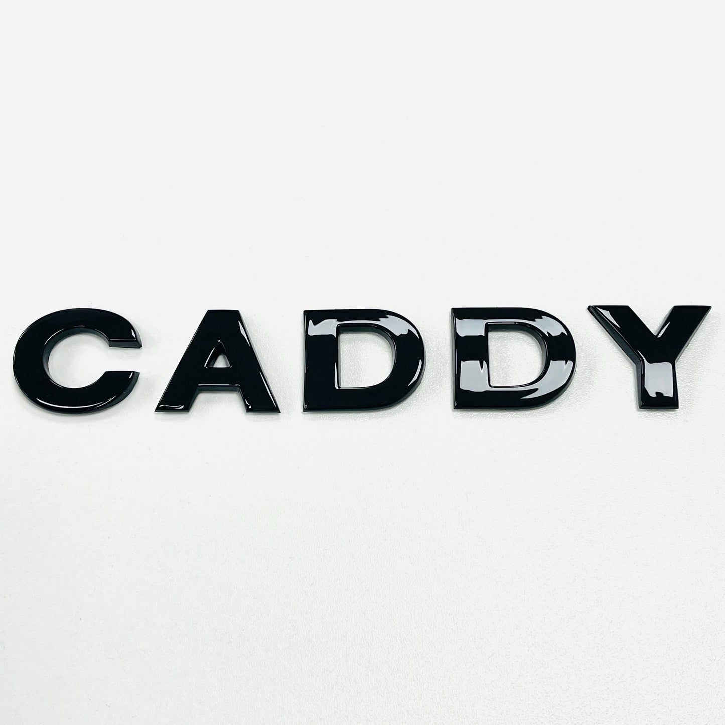 CADDY gloss black badge